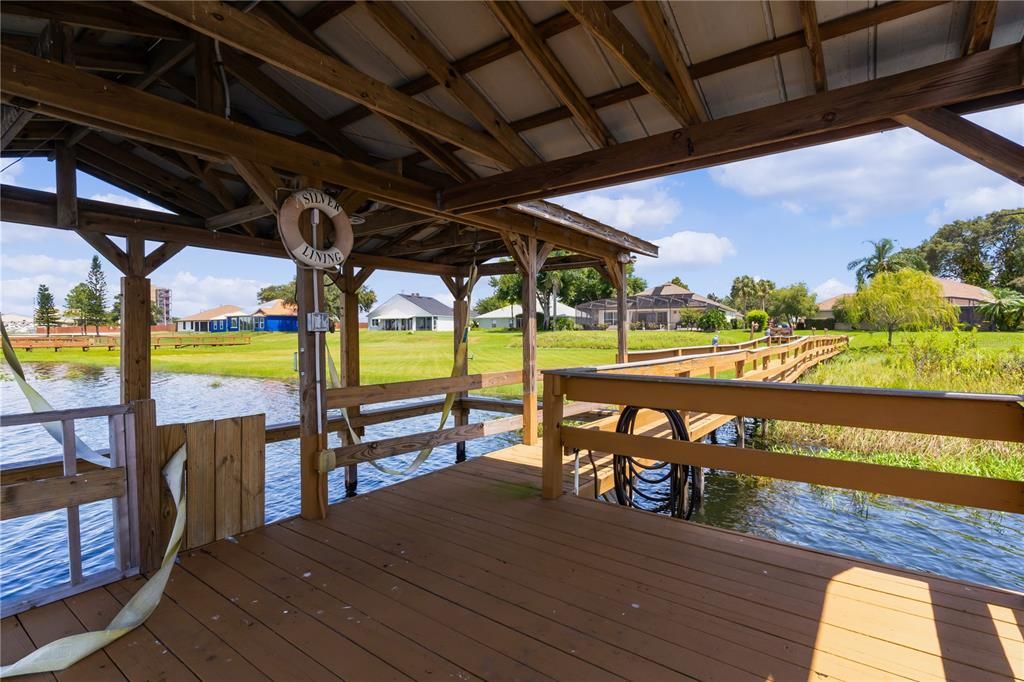 This property features a private boat dock complete with a boat lift and charming boathouse, offering convenient access to the water. It's the perfect setup for boating enthusiasts, providing easy storage and launching for your boat, while also creating a peaceful spot to relax and enjoy serene lake views. Ideal for making the most of waterfront living!