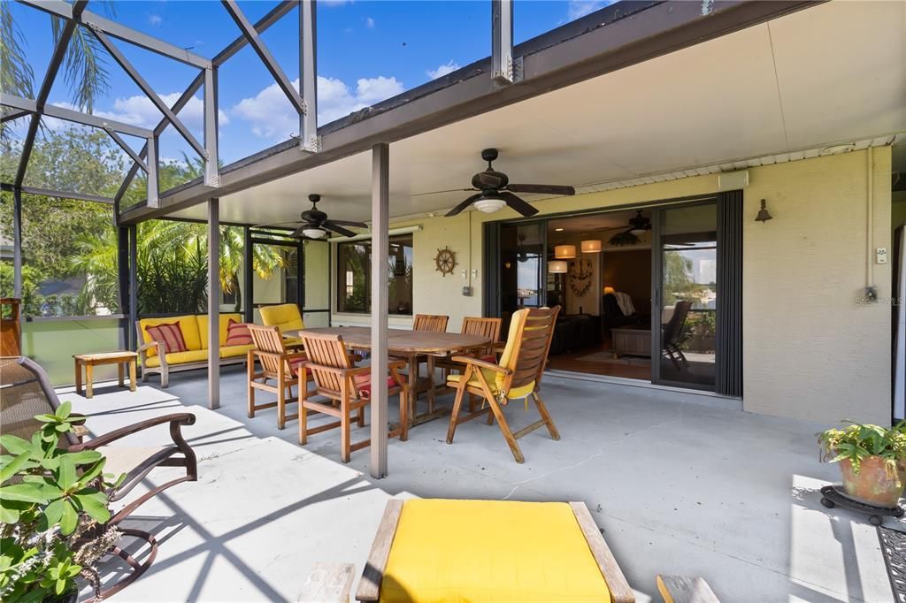 This spacious, screened-in back patio is the perfect spot to unwind, featuring two ceiling fans for comfort and offering stunning views of the lake and private boat dock. Whether you're enjoying a morning coffee or an evening breeze, this peaceful outdoor space is ideal for soaking in the serene waterfront setting.