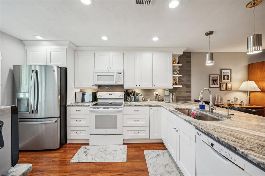 Beautiful laminate flooring, granite countertops and tile backsplash.