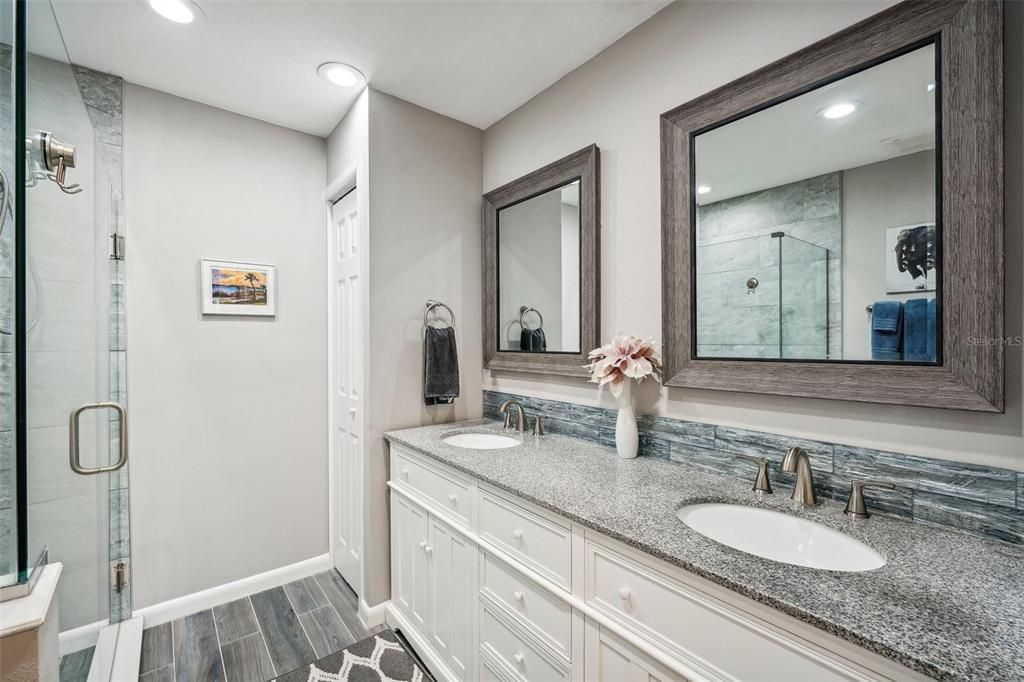 Updated master bathroom with duel sinks and granite countertops.