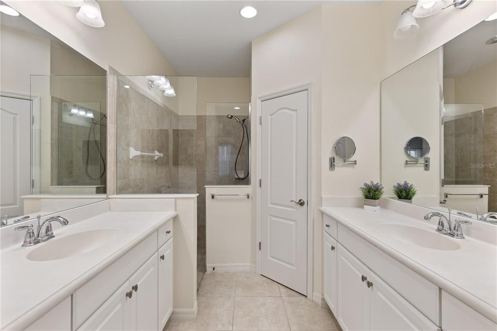 Owners ensuite bathroom featuring dual vanities, a walk-in shower, and water closet.