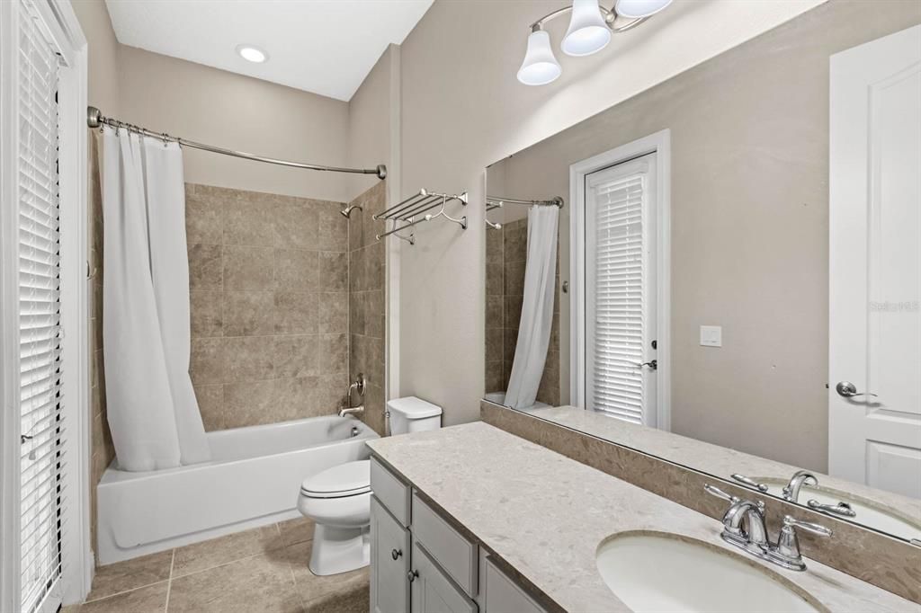 Guest bathroom with access to the pool lanai