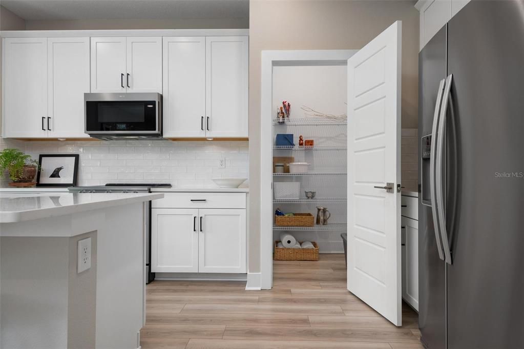 Kitchen With Wood Cabinets and Quartz Counters w Walk In Pantry