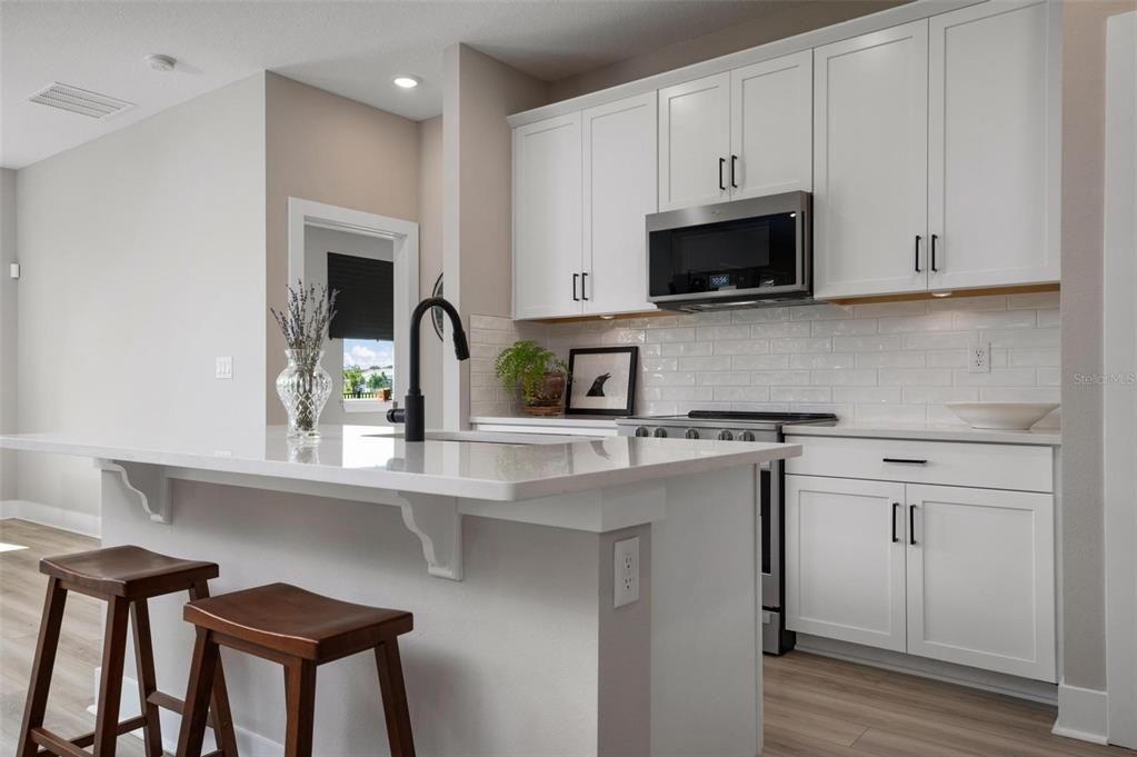 Kitchen With Wood Cabinets and Quartz Counters