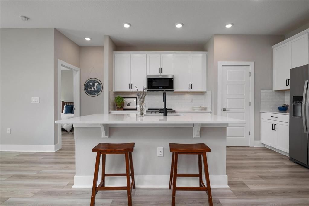 Kitchen With Wood Cabinets and Quartz Counters w Walk In Pantry