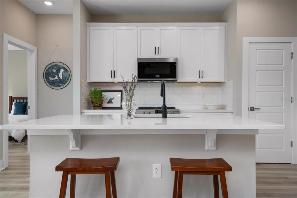 Kitchen With Wood Cabinets and Quartz Counters