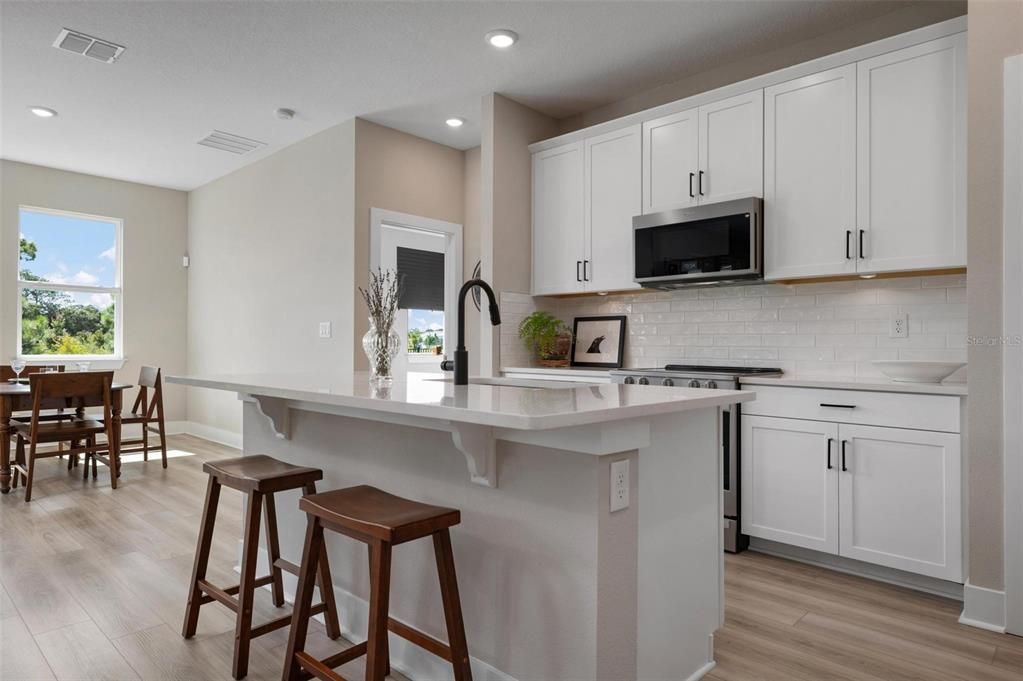 Kitchen With Wood Cabinets and Quartz Counters