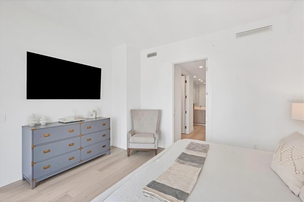 Primary bedroom with dual walk-in closets.