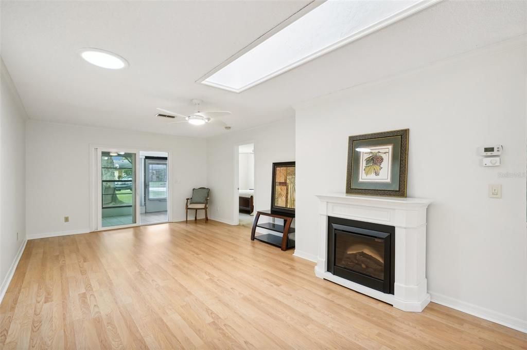 Large living room with sliders to enclosed back porch