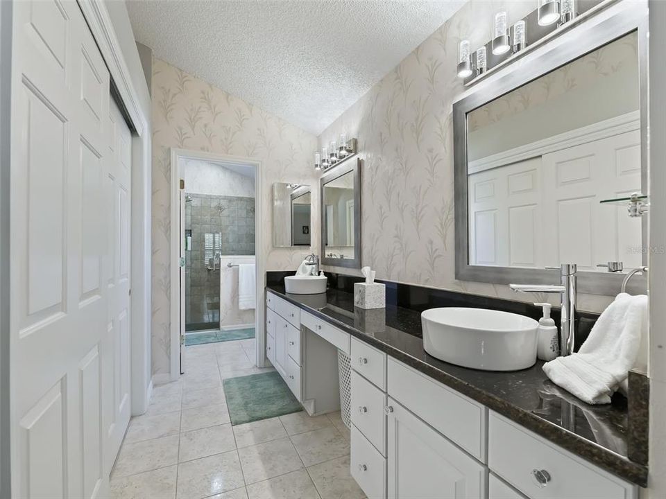 Stone counter tops with above counter bowl sinks, upgraded faucets and gorgeous fixtures.