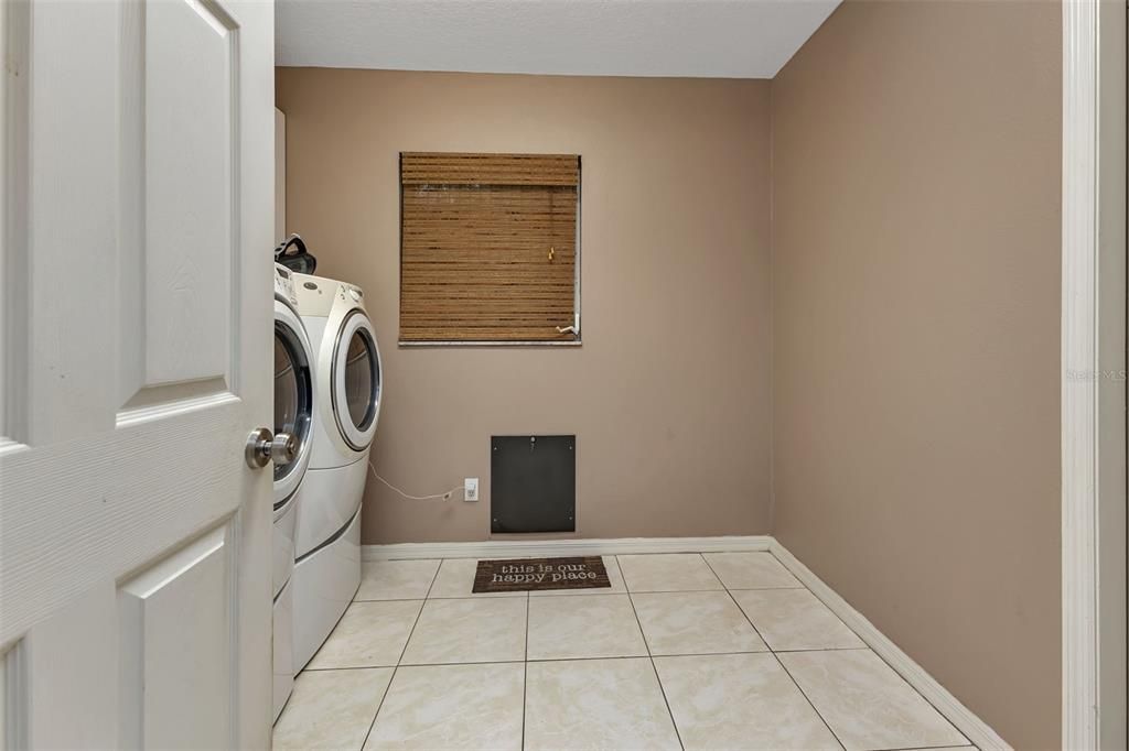 Laundry Room with Dog Door to Outside Dog Run