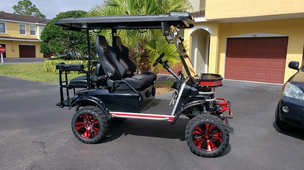 Club Car DS with lithium ion batteries, Navitas controller and Motor, on-board charger w/retractable power cord, 6" independent suspension lift, custom racing seats, 4-seater, road legal capable configuration, off road rims/tires, brush guard/winch, LED lighting, front/rear storage racks, and 4 speaker stereo system. Included with home sale.