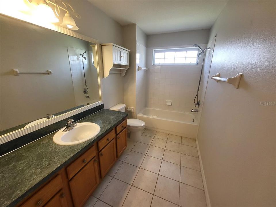 Spacious full bath with shower/tub combo and oversized vanity.