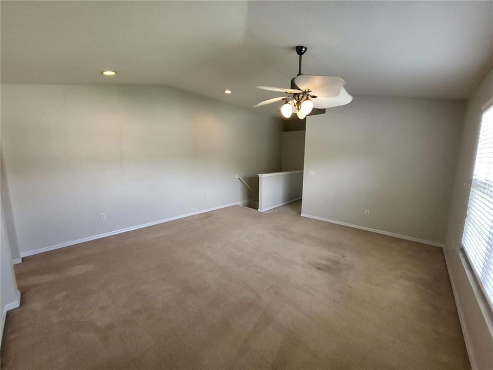 Bonus area looking towards stairs and hall to Primary Suite