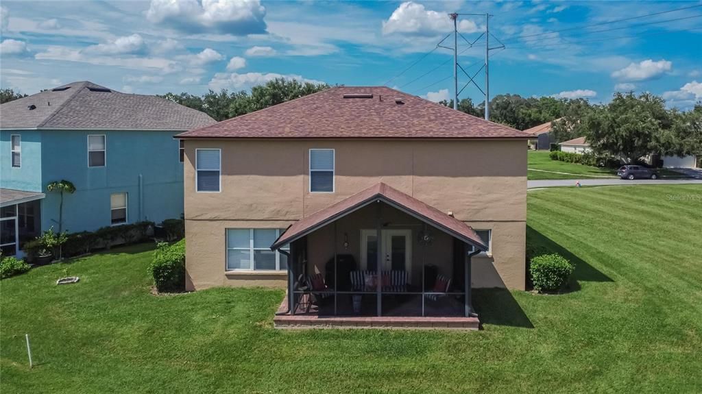 Back of the house with covered screened porch!