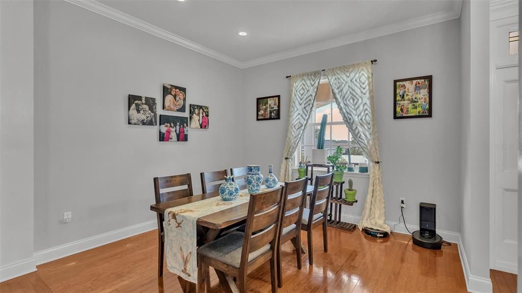 Dining room with wood floors and crown molding