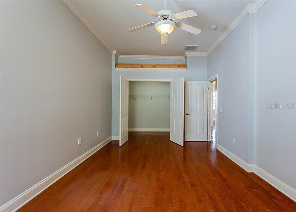 2ND BEDROOM SHOWING REAL WOOD FLOORS AND HUGE WALK IN CLOSET