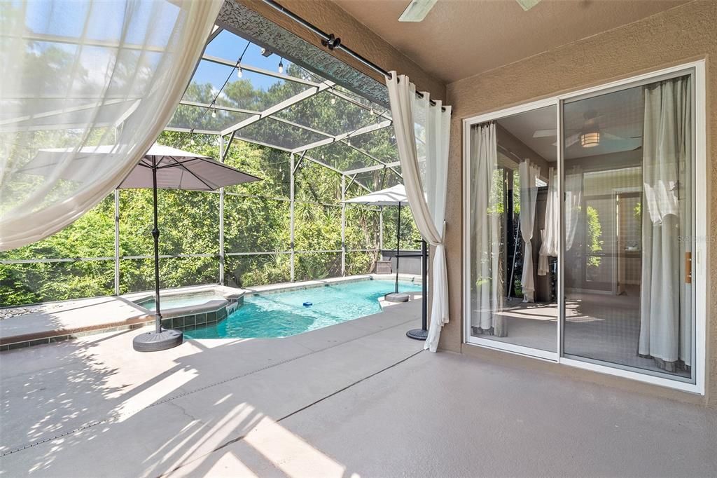 Primary bedroom sliding doors lead to covered lanai