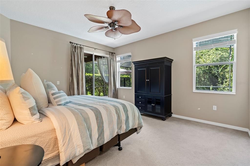 Spacious primary bedroom with sliding doors to your covered lanai