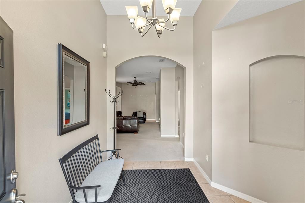 Foyer features arched entrance and decorative niche