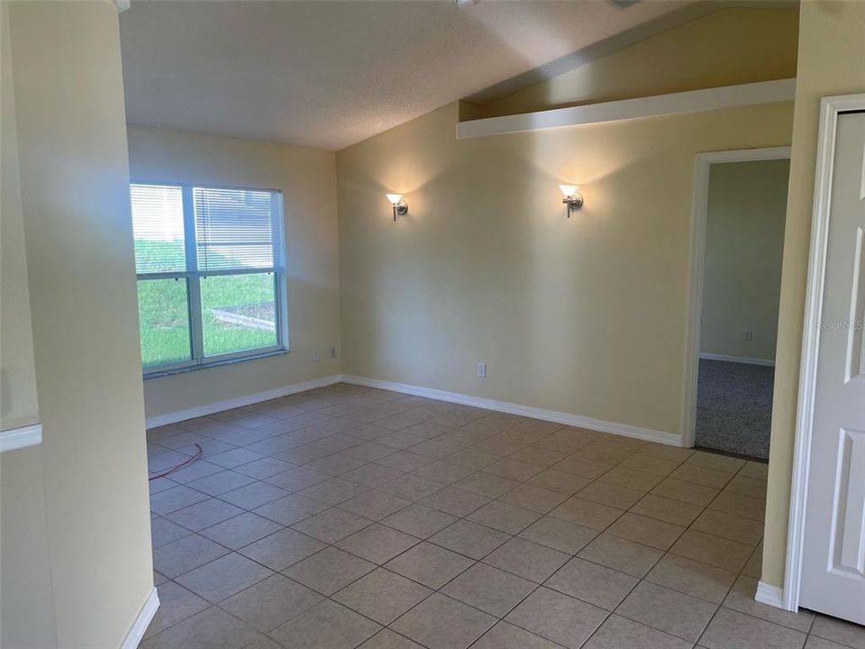 Family/social area of entrance/great room.  Split bedroom design - shows entrance to primary bedroom and a coat closet on the right