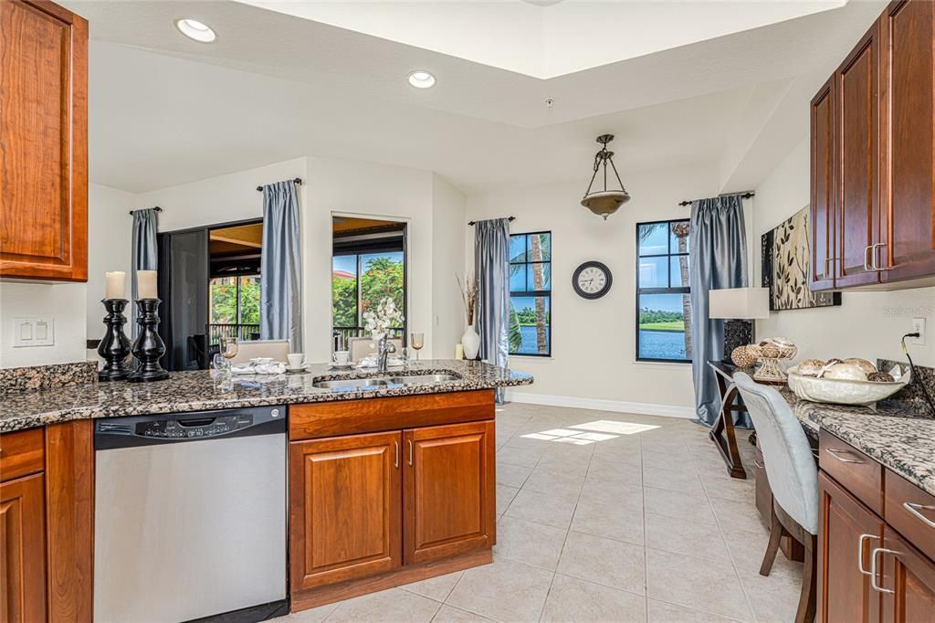 Enchanting  water views frame this well designed kitchen with cafe dining space