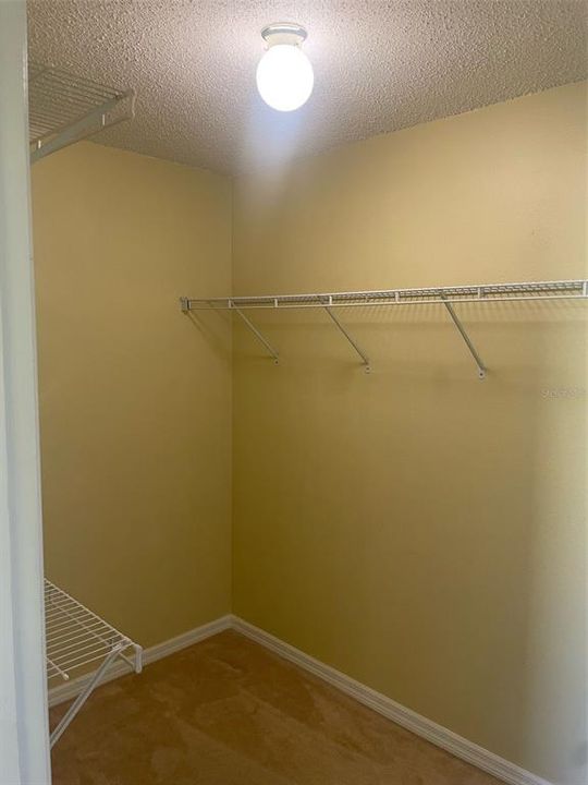 Primary bedroom walk in closet