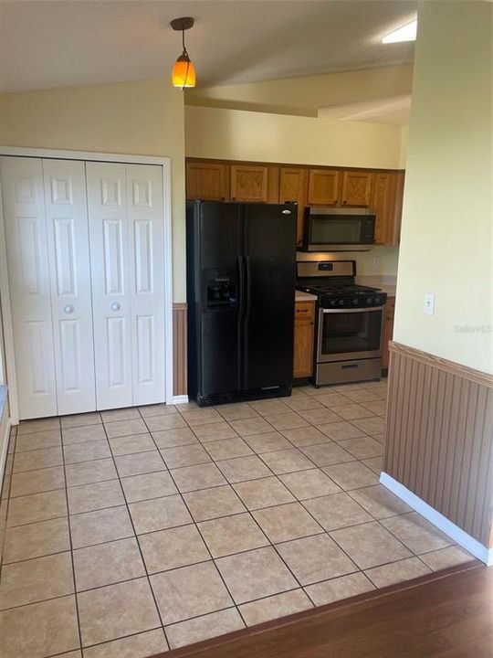 Eating space in kitchen has a nice double wide pantry closet.