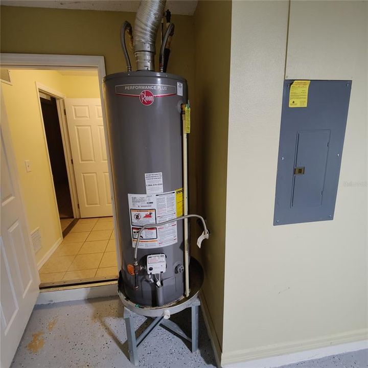 Gas water heater and entry to laundry/utility room.