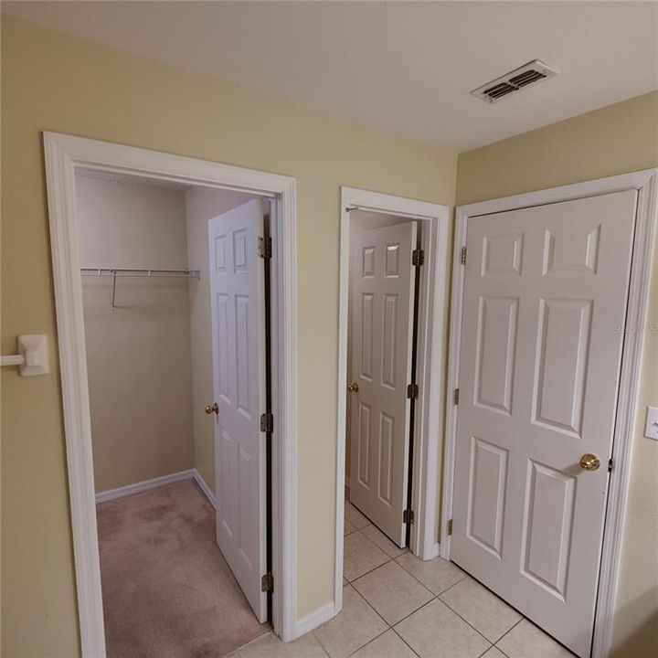 Primary bathroom has a private toilet room with a door.  Walk in closet on left