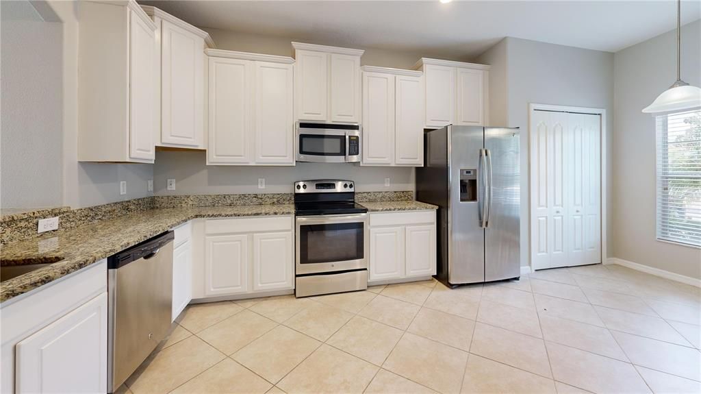 Kitchen area, showing stainless steel appliances and ample cabinetry.