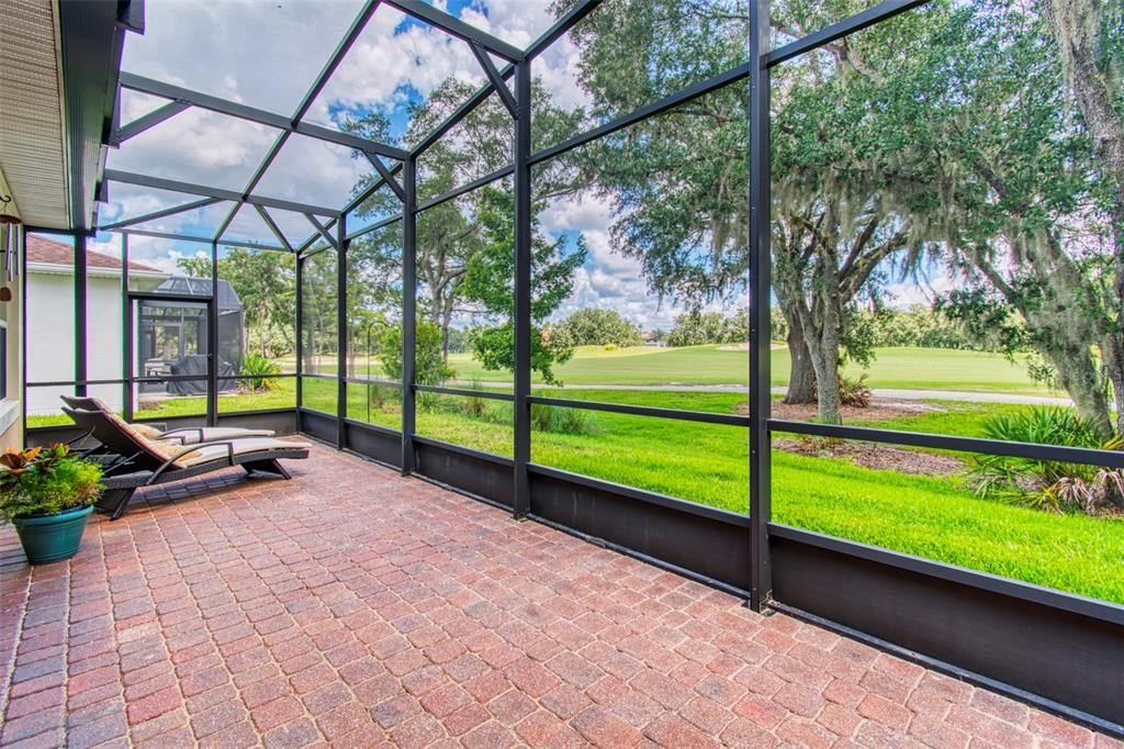 This EXTENDED, FULL-WIDTH LANAI provides a panoramic view of the Oaks 18th fairway and green!