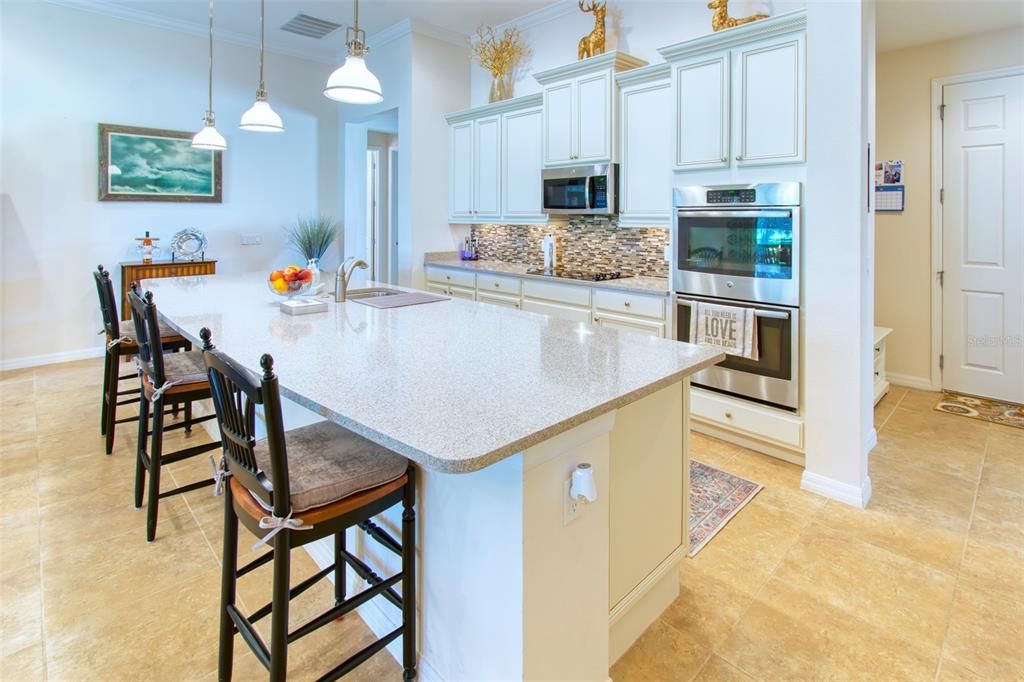 The kitchen is a chef's delight - gourmet option with enhanced detailing, double ovens, smooth cooktop - this home adds beautiful QUARTZ counters and a glass and marble BACKSPLASH