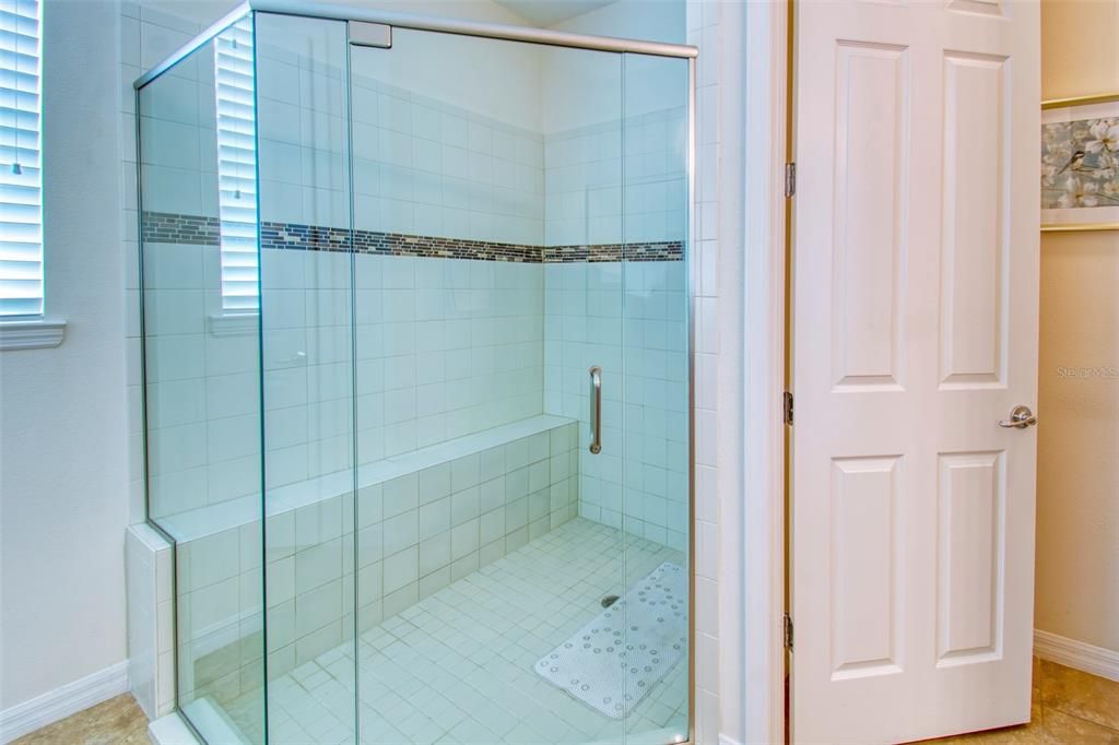 The clean look of glass, large tile with a hint of accent in the listello