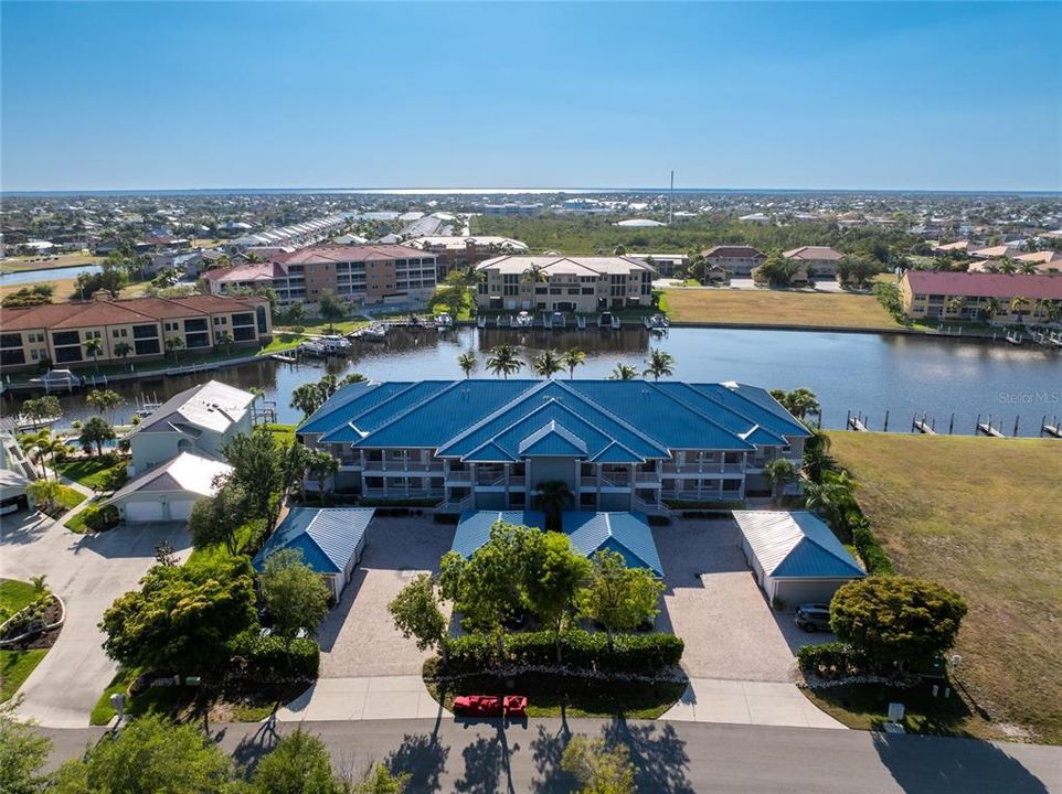 Top floor end unit overlooking  268 wide waterway with quick harbor access, private garage