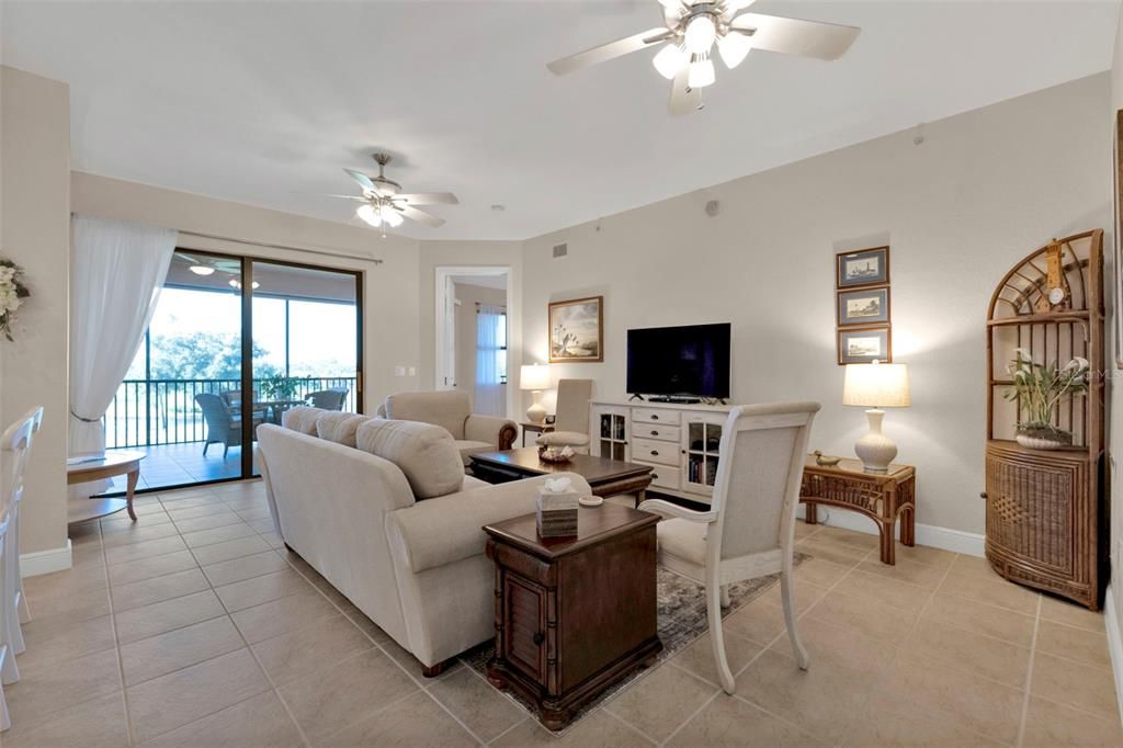 Living room with sliders to the lanai overlooking the golf course and ponds