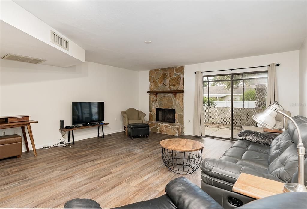 Living room view to back patio and fireplace area