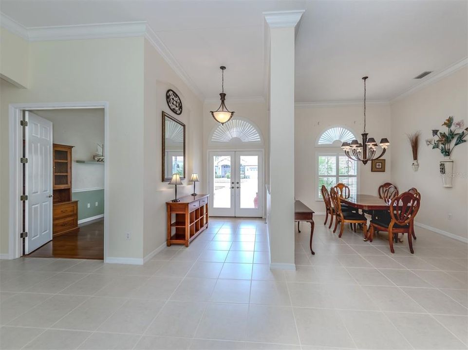 The large foyer is adorned with double glass doors.