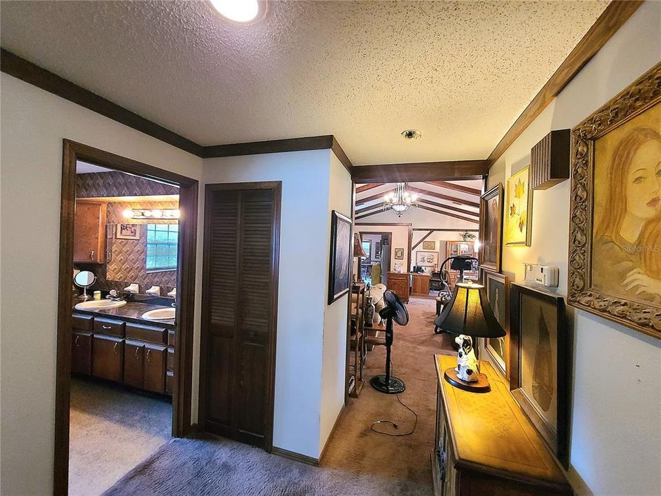 Hallway showing linen closet and entry to living room