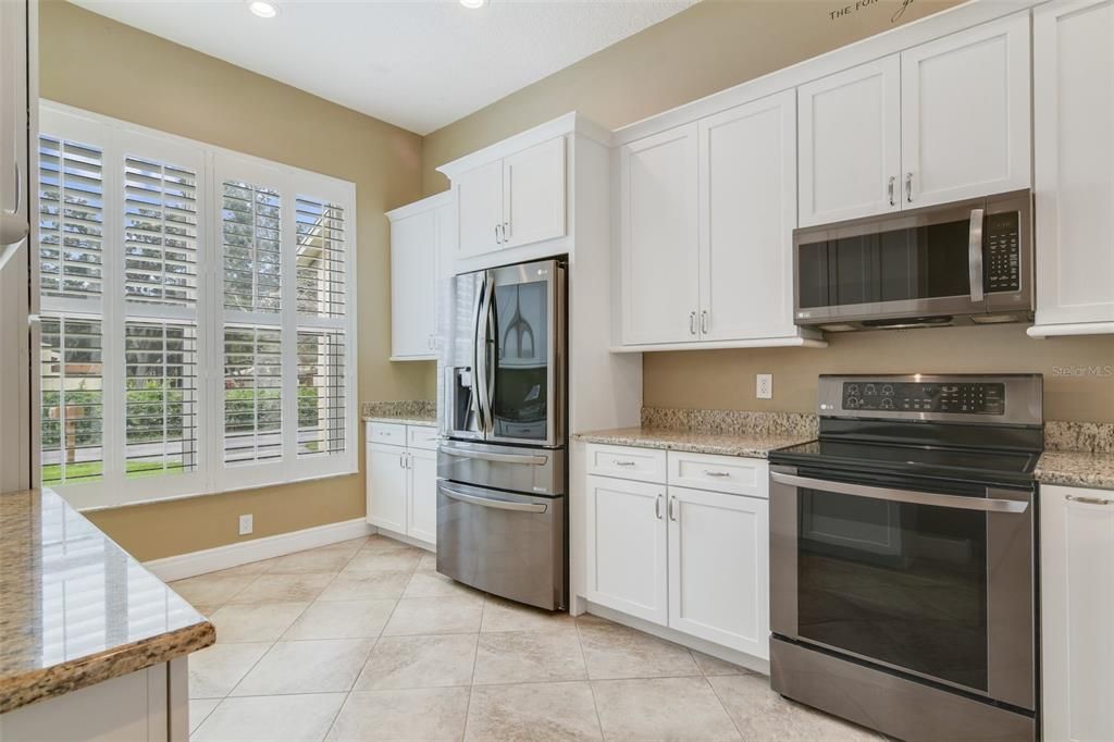 The home chef will appreciate the kitchen makeover now featuring UPGRADED STAINLESS STEEL APPLIANCES, shaker style cabinetry for ample storage, granite countertops and a passthrough breakfast keeps you connected when gathered with family or entertaining guests.