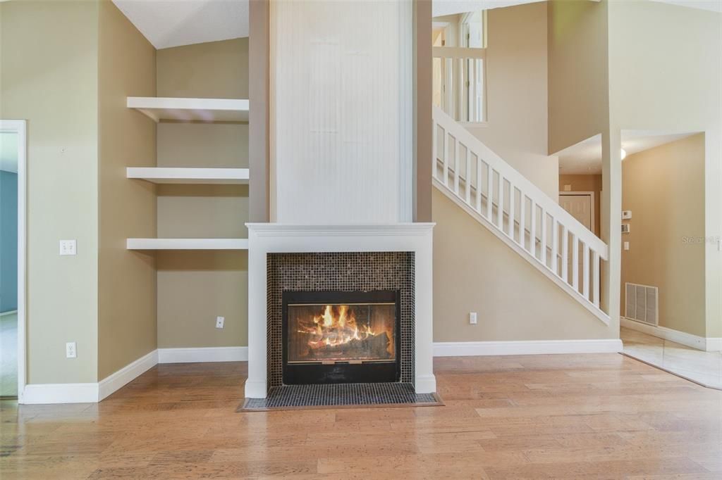 The lovely fireplace and built-in shelving serves as a focal point in your open living/dining.