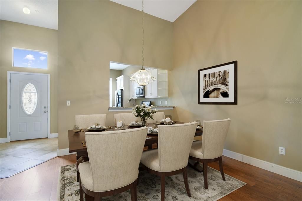 The living and dining areas are open to each other under VAULTED CEILINGS with charming built-in shelving to the side of the fireplace. Virtually Staged.