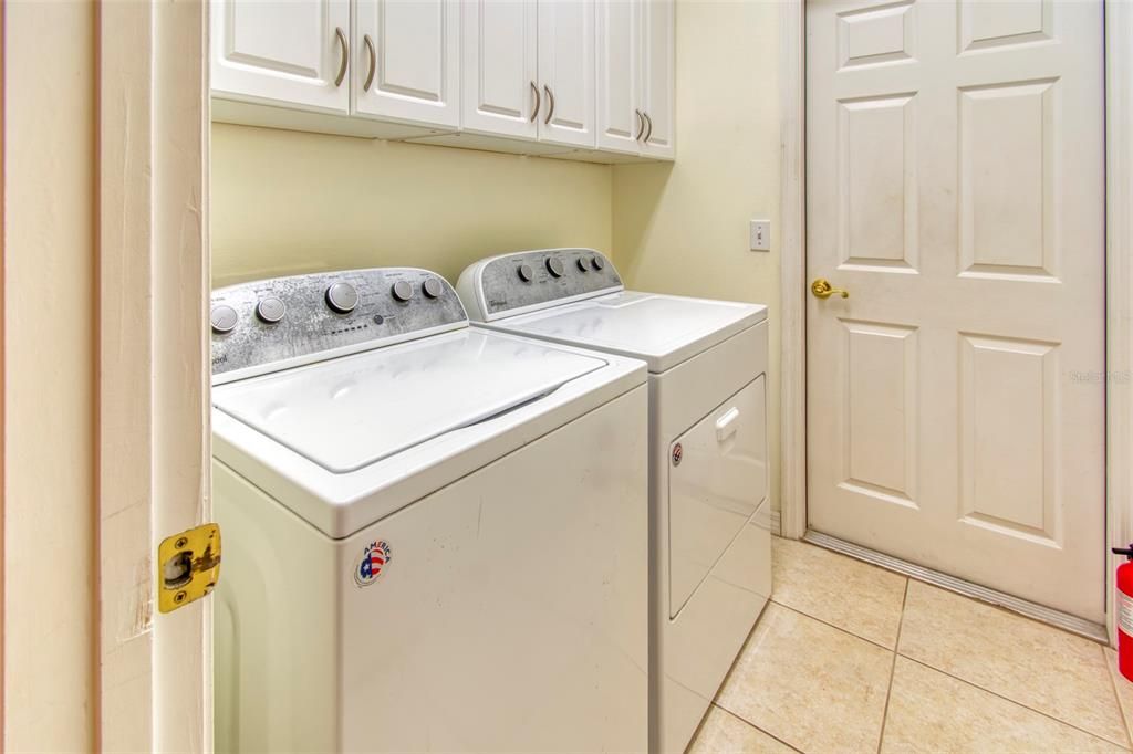 The service entry is a handy 'pass through' to the attached 2 car garage - with storage cabinets above the washer/dryer