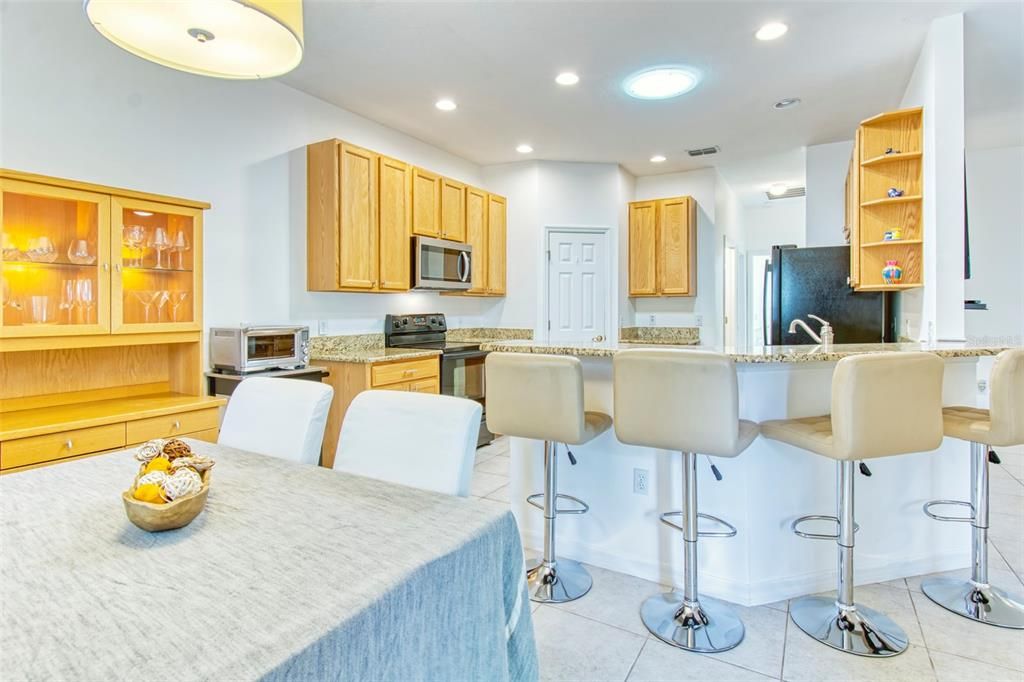 Add the raised breakfast bar along with the dining area - you can entertain in style....there is a wonderful solar-tube which floods the space with natural light!