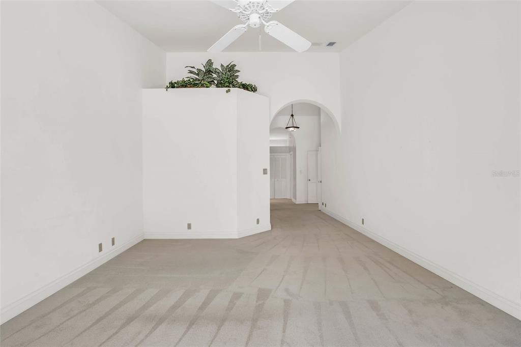 Owner's suite featuring light-colored flooring and fan