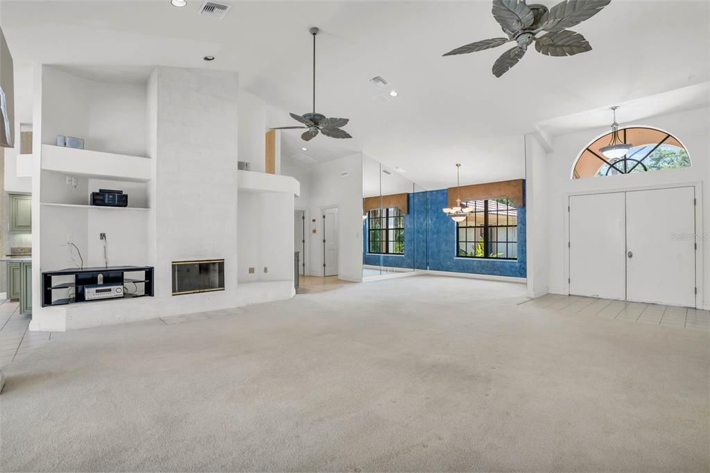 Open-plan living room with access to outdoor pool area