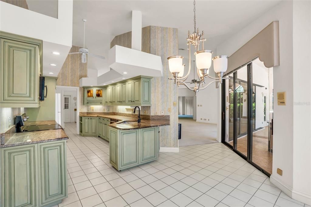 Kitchen with chandelier, ample counter space, and pool views