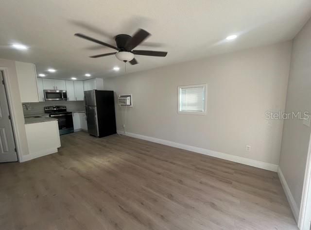 Living room, kitchen area shown vacant