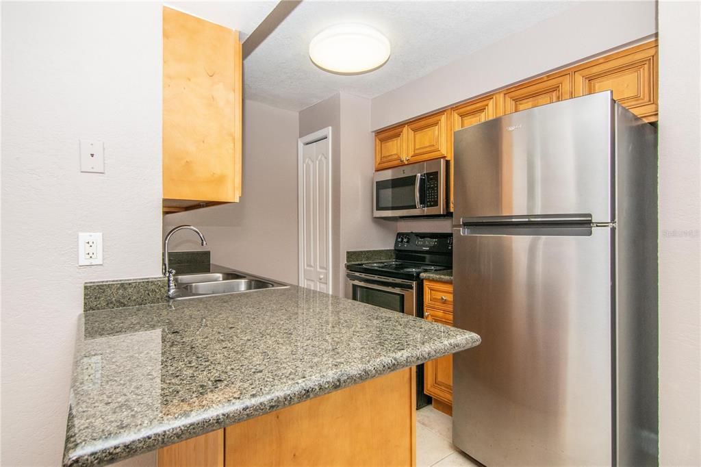 Kitchen w/ Wood Cabinets, Granite Counter-Tops, Stainless Steel Appliance Package