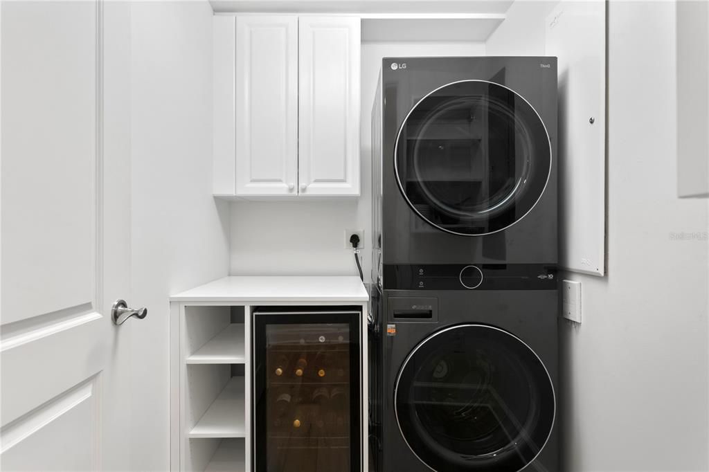 laundry room with new washer and dryer and wine refrigerator